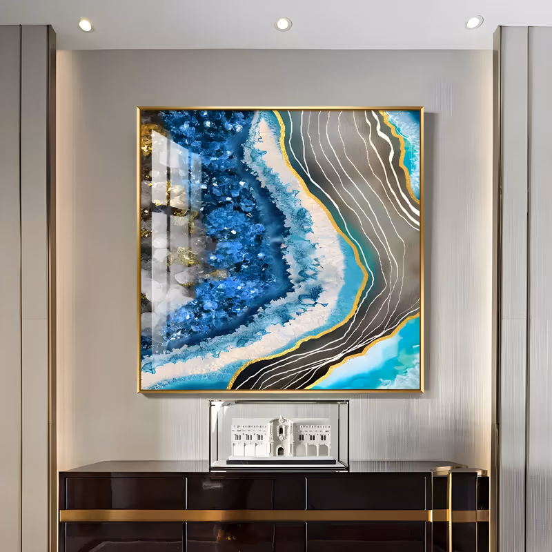 a large square textured painting of a geode slice, a core of raised blue crystal druzy on the left edged in white and turquoise agate rings, with gold nuggets and gray banded lines, in relief resin