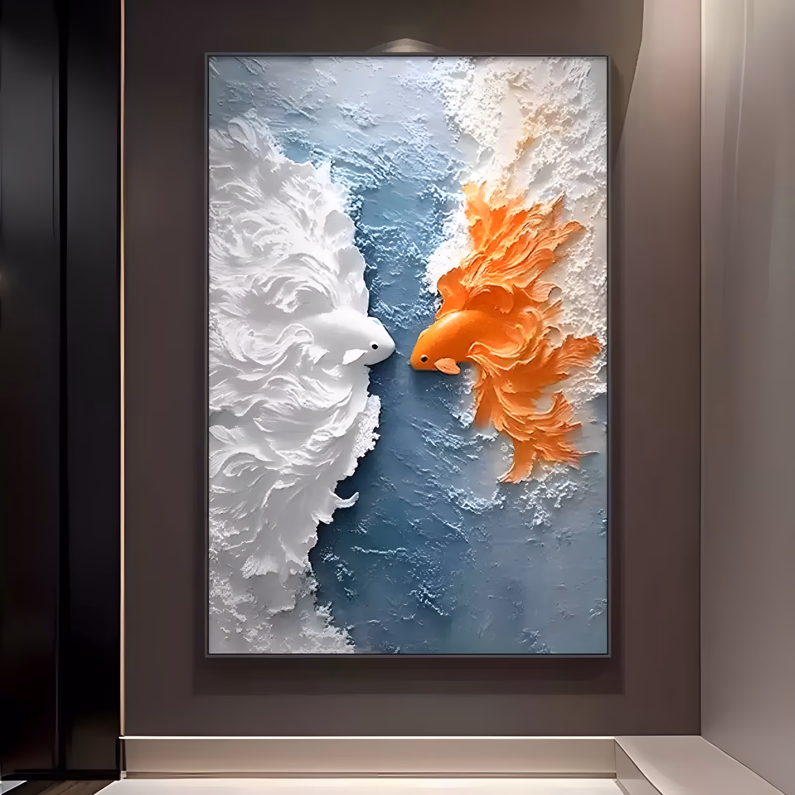 a large vertical relief painting of two koi facing each other, one white on the left and one orange on the right, their long fins carved into feathered plaster ridges over a blue-gray water ground