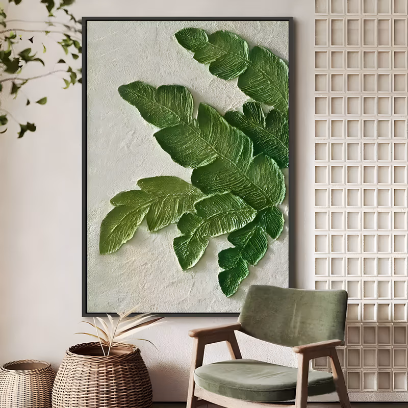 a large vertical plaster relief painting of three sculpted fern fronds spreading from the right edge toward the center, deep to yellow-green leaves raised above a rough cream ground