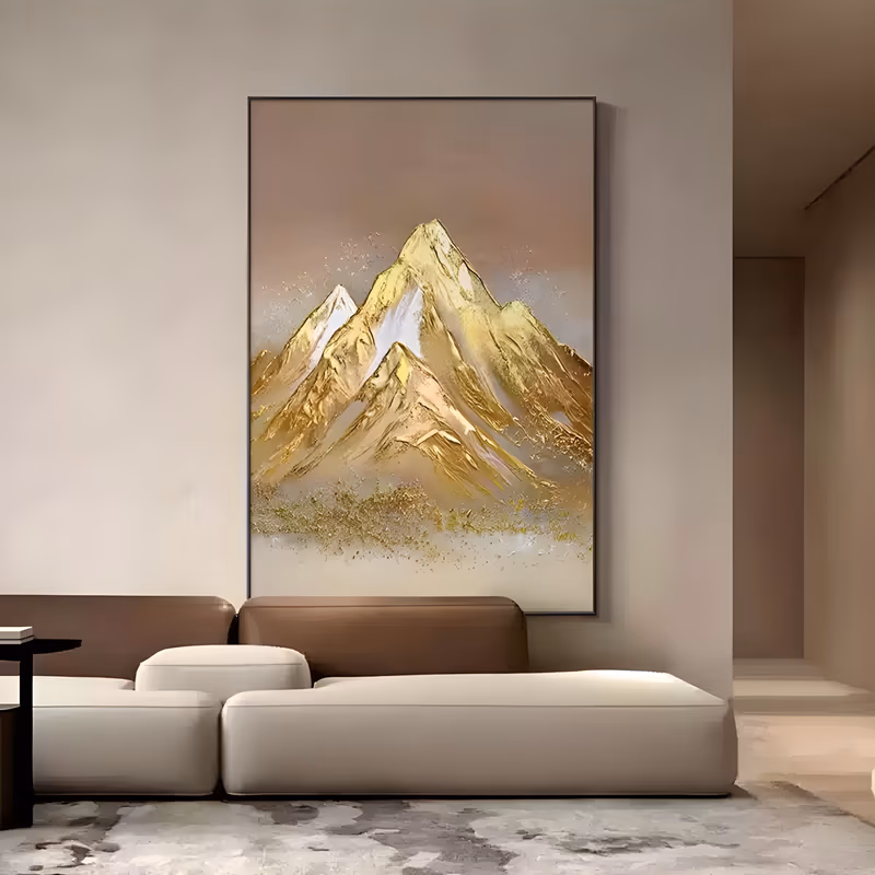 a large vertical textured landscape painting of gold leaf mountain peaks rising in the center against a soft beige sky, with white snow highlights and flecked gold at the base, in thick impasto