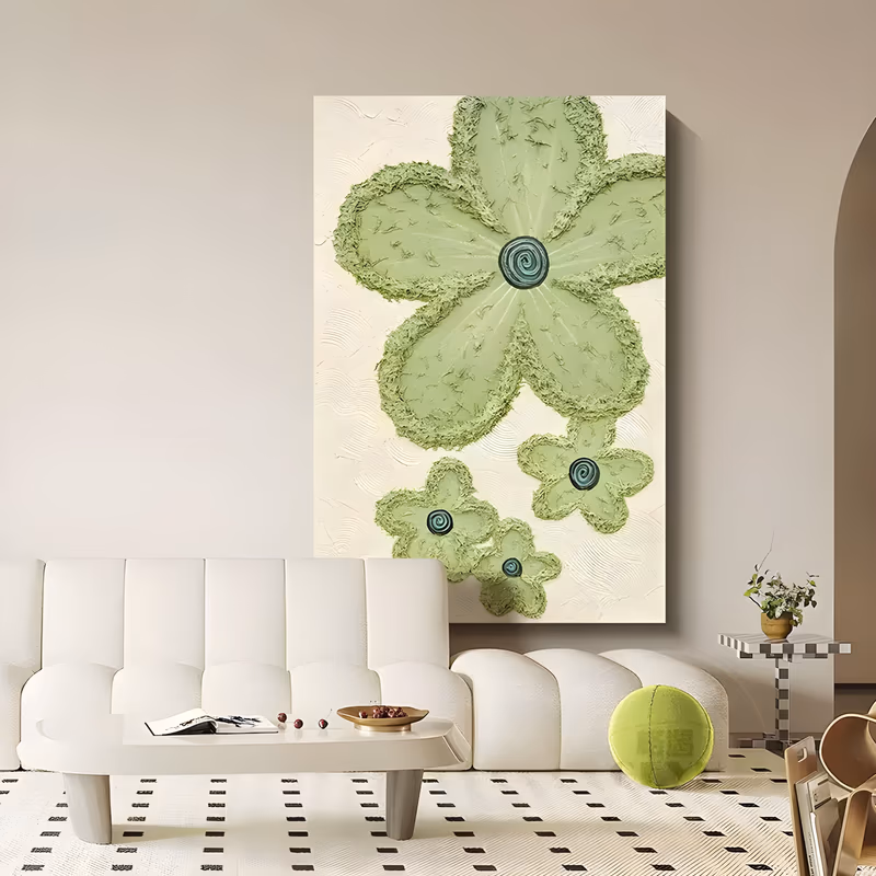 a large vertical plaster relief painting of one big sage green flower with a dark teal spiral center, three smaller blooms below it at the right, all raised over a combed cream ground