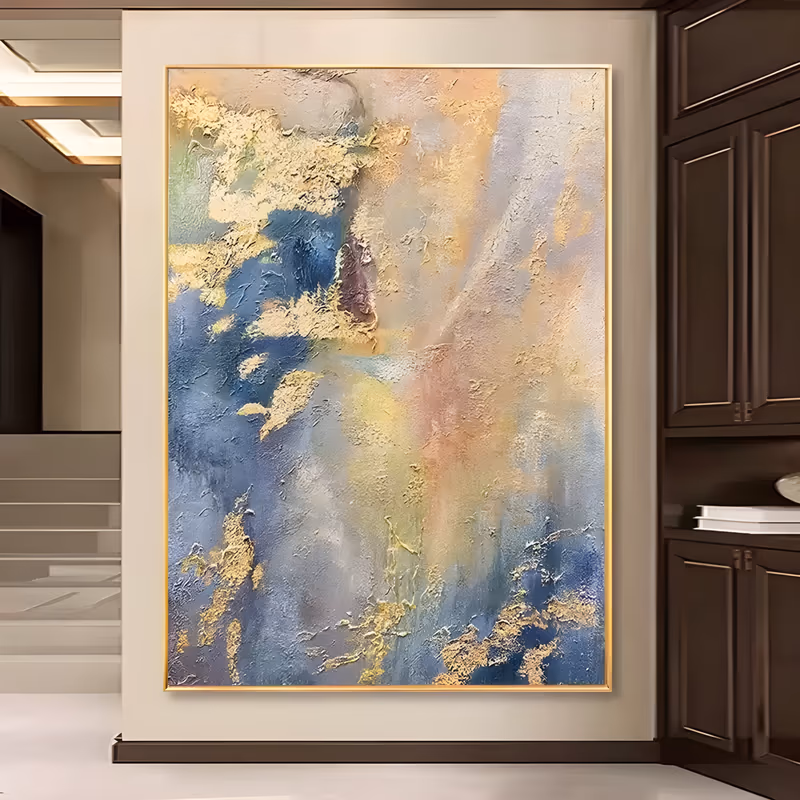 a large vertical abstract painting of soft blue, apricot and cream fields blending down the canvas, with torn gold leaf drifting along the left and lower areas, in thick troweled plaster texture