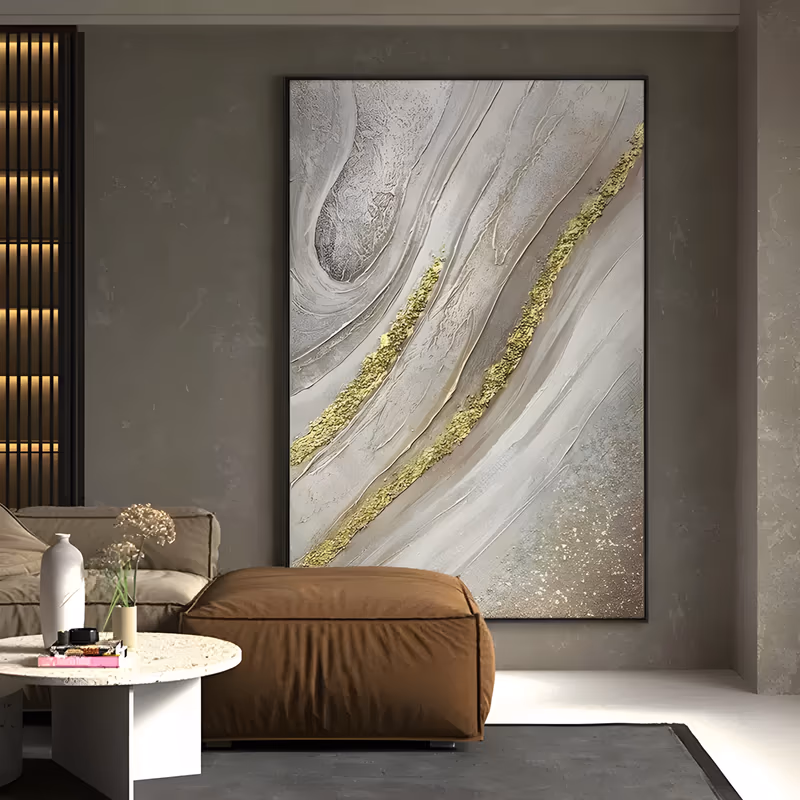 a large vertical plaster relief painting of pearl gray and cream strata sweeping on the diagonal, two rough gold leaf veins running between them and a drift of gold speckle at the lower right