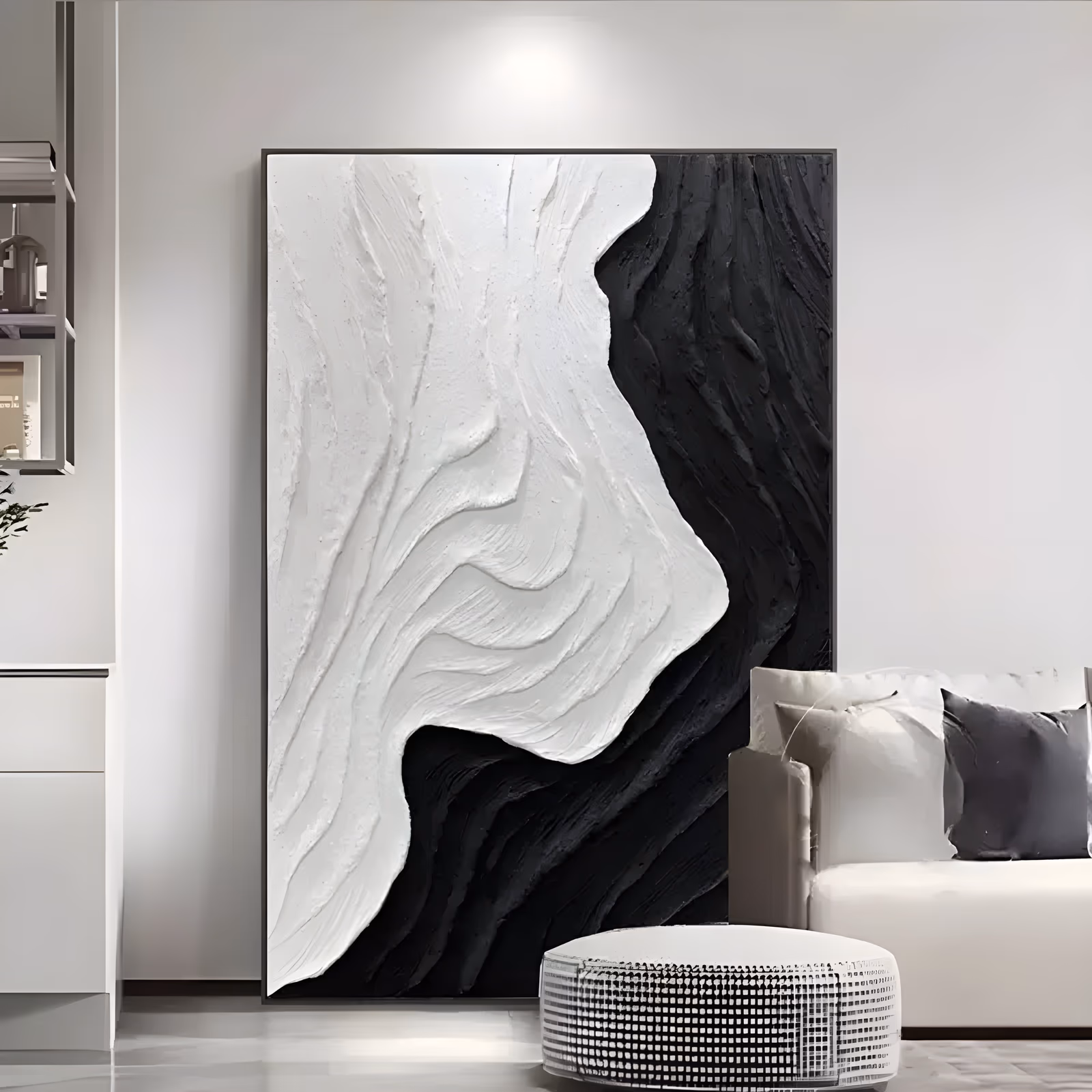 a large vertical black and white relief painting of a thick white plaster wave form curving down the left side against a rough black field on the right, in deep sculpted plaster