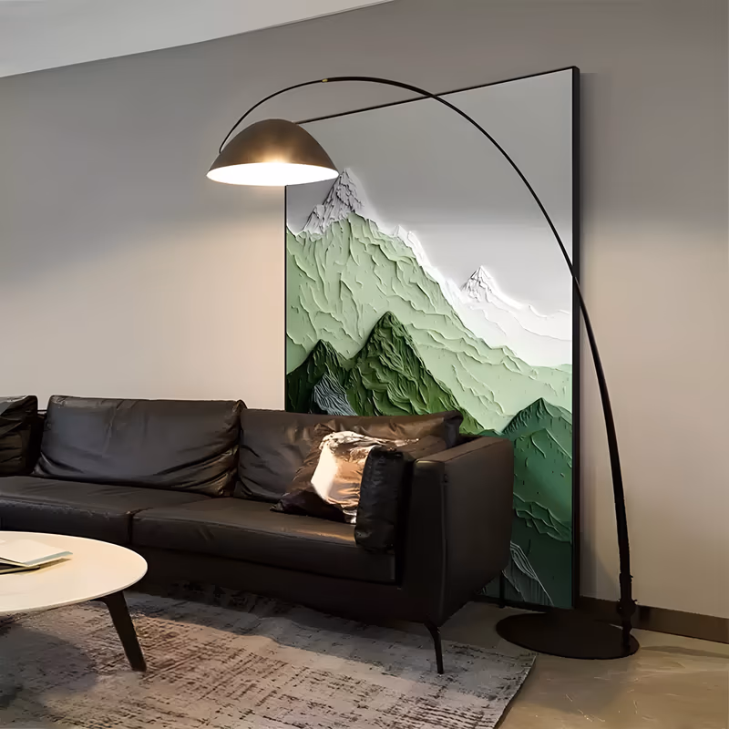 a large vertical sculpted plaster painting of a mountain range in tiers, deep green ridges at the base rising to mid green slopes and white snow-capped peaks against a pale gray sky, in carved relief