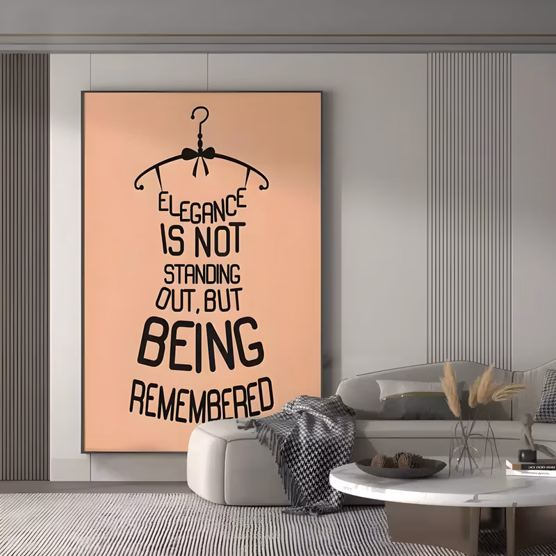 a large vertical minimalist typographic painting of a hand-lettered quote about elegance arranged in the shape of a dress hanging from a black wire hanger, black type on a peach ground, in flat paint