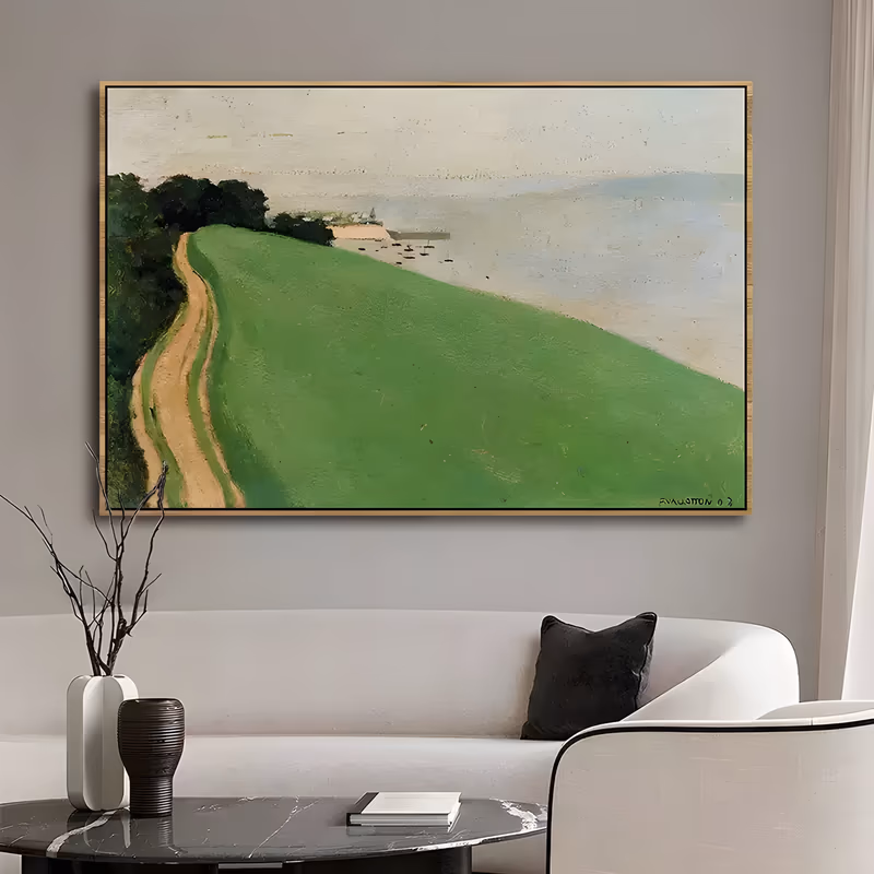 a large horizontal impressionist landscape painting of a broad green headland, a sandy track curving down its left edge past dark trees to a small harbor with moored boats, pale gray sea and sky beyond, in matte oil