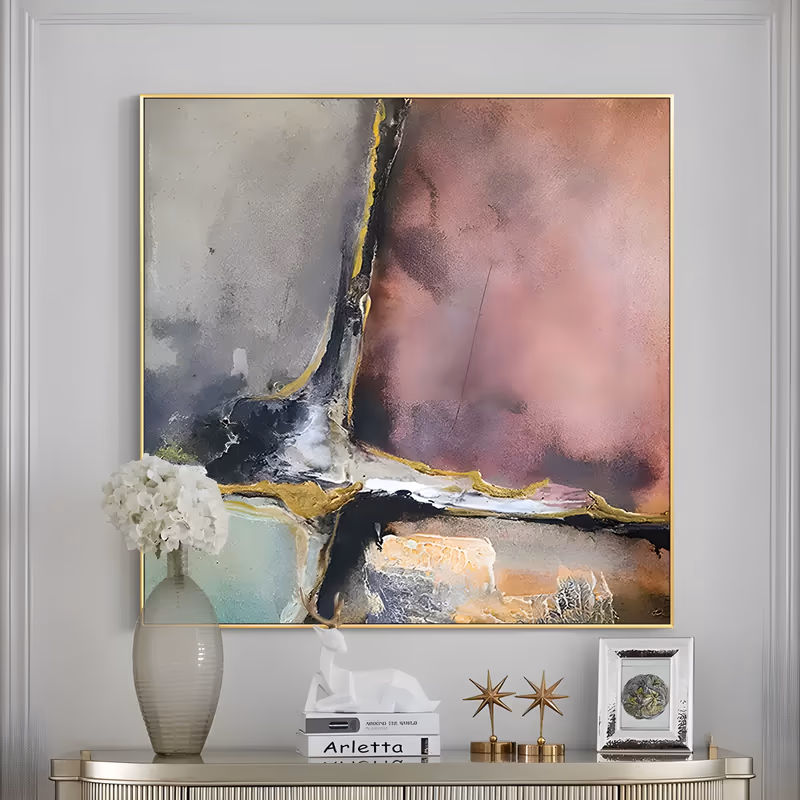 a large square abstract painting divided into fields of dusty mauve, warm gray and mint, split by a black and gold vein that runs down the center and along the lower third, in matte textured paint