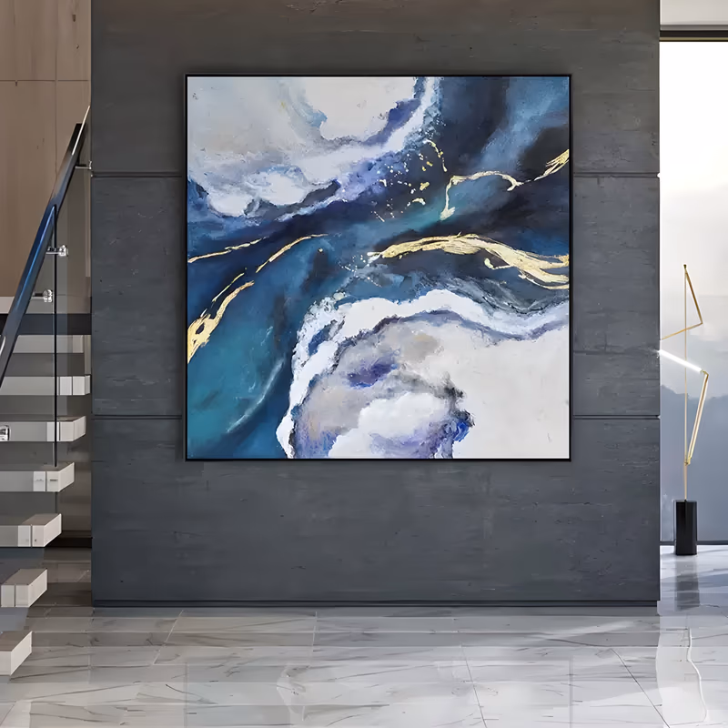 a large square abstract painting of teal, navy and white cloud-like masses swirling around the center with thin gold leaf veins running through the middle, in smooth hand-painted acrylic