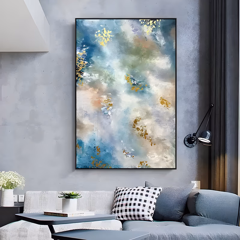 a large vertical abstract painting of misty cloud banks in soft blue, sage green and cream, scattered with irregular gold leaf flakes that cluster down the left edge, in brushed acrylic