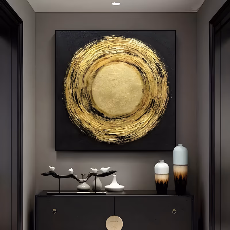 a large square minimalist painting of a smooth gold disc ringed by thick swirling gold and black brushwork at the center of a matte black ground, in heavy metallic impasto