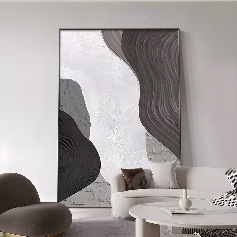 a large vertical sculpted relief painting of wave ridges, a dark charcoal band curving down the right side and a black form rising at the lower left, framing a broad chalk-white plaster field, in deep relief