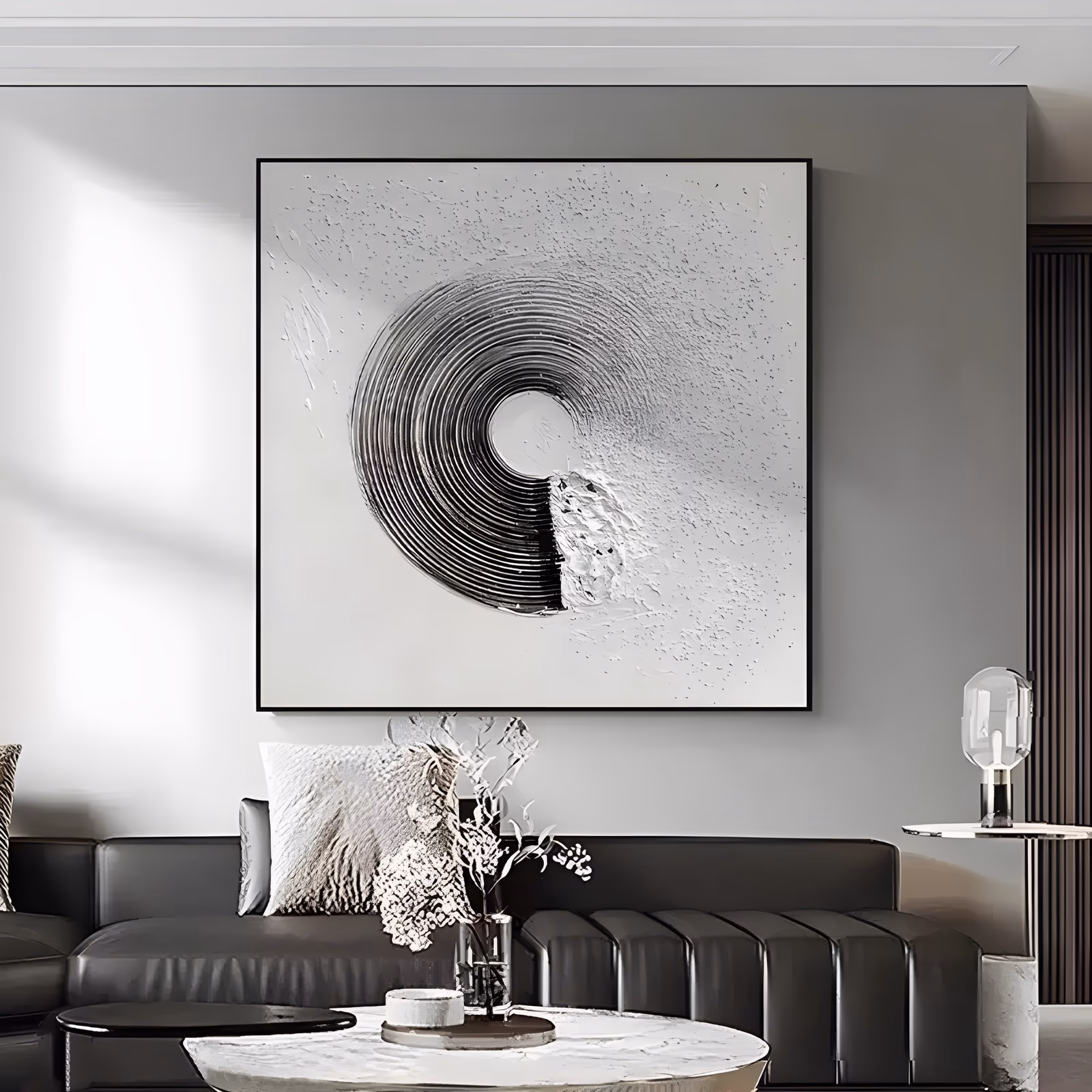 a square minimalist painting of a single ridged spiral ring curving from black into silver gray, set left of center on an off white ground flecked with raised speckles and knife spatter, in sculpted relief
