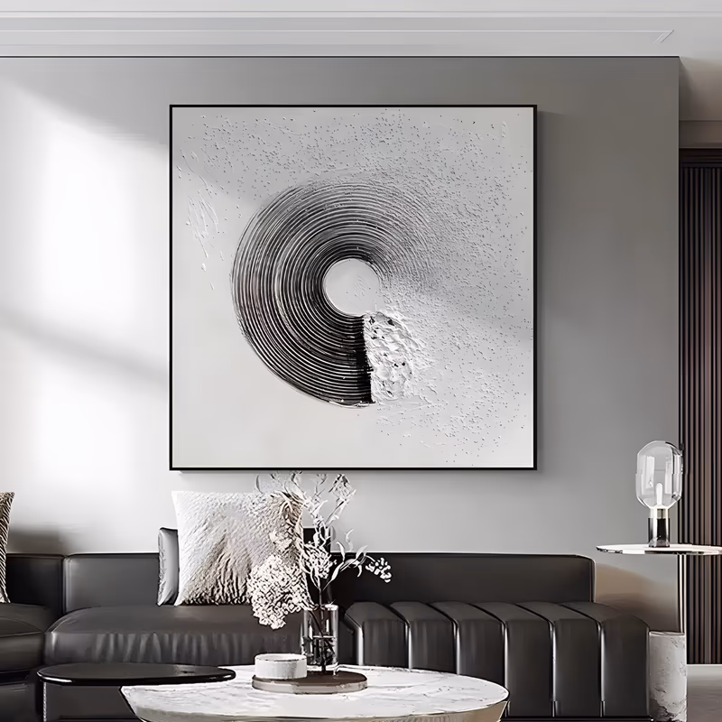 a square minimalist painting of a single ridged spiral ring curving from black into silver gray, set left of center on an off white ground flecked with raised speckles and knife spatter, in sculpted relief
