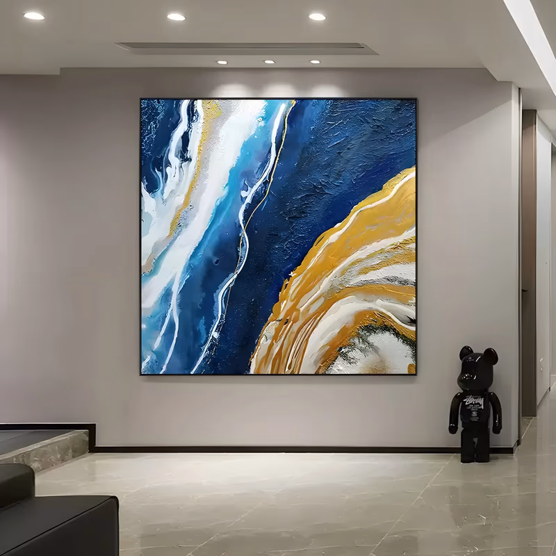 a large square abstract painting of a deep navy field with white and pale blue flow lines running down the left and a broad golden yellow arc curving through the lower right, in thick impasto oil