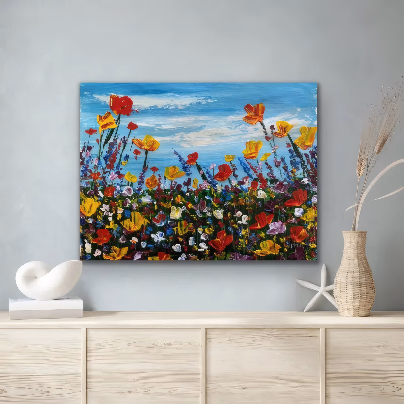 a wide horizontal impressionist painting of red, yellow and orange poppies on tall stems with purple lupines below, rising against a bright blue sky streaked with white cloud, in thick knife impasto