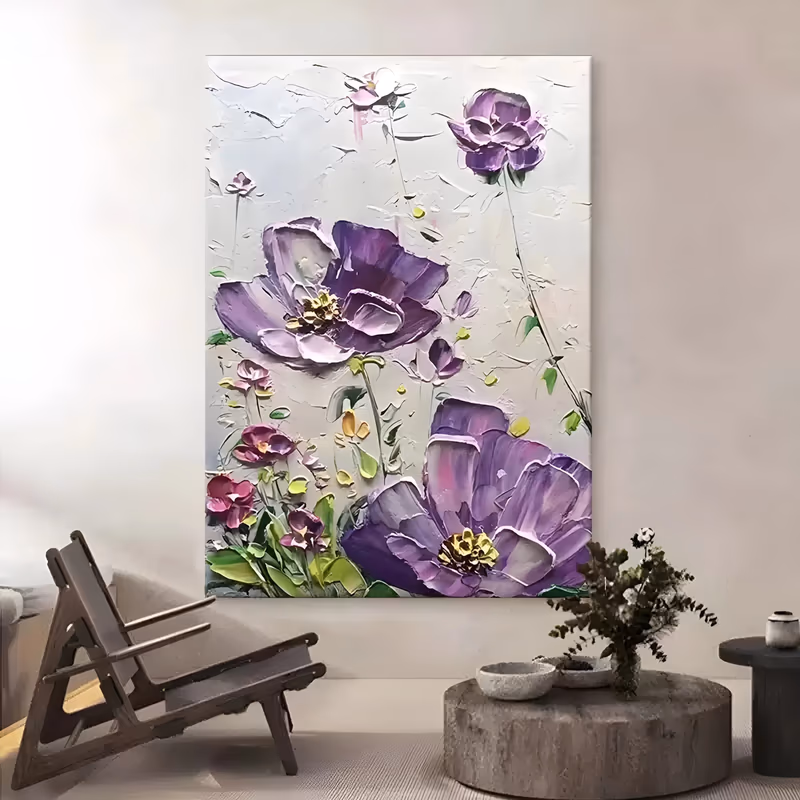 a large vertical relief painting of two open violet poppies with gold centers at lower right and upper left, small pink and magenta buds and green leaves below, sculpted in raised plaster on a soft gray ground