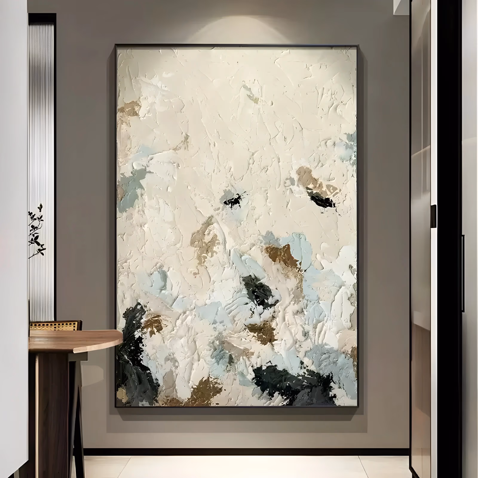 a large vertical abstract painting built from heavy cream and beige knife strokes, with patches of pale blue, tan and near-black clustered low in the frame, in thick impasto that casts real shadow