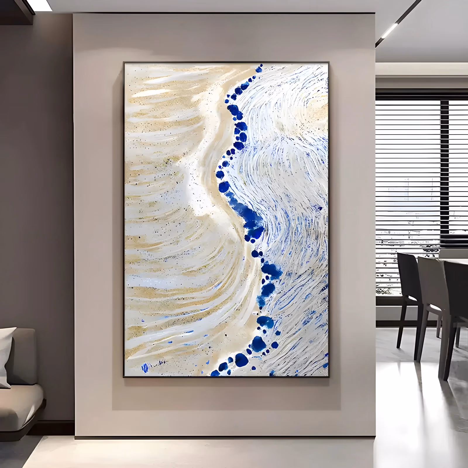 a large vertical textured painting of a shoreline seen from above, with ridged beige sand on the left meeting white swirling foam on the right and a line of cobalt blue blobs running between them, in thick paint