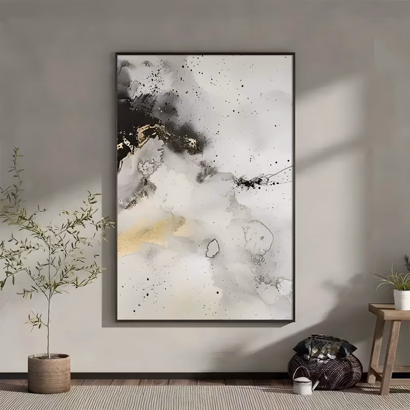 a large vertical abstract painting of pale gray ink wash clouds with black splatter falling near the top left, a cream and gold patch below it, and wide white space at the lower right, in thin flowing acrylic