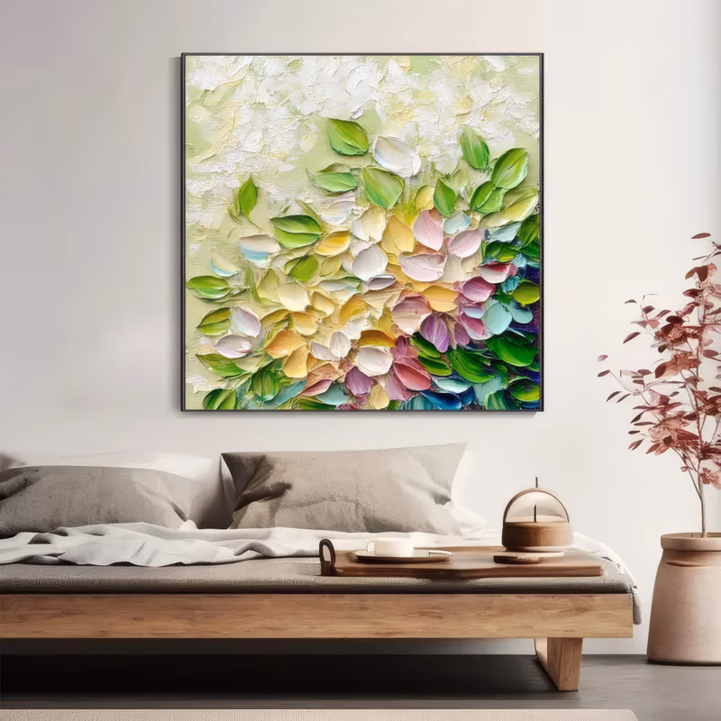 a square abstract floral painting of small petals scattered from the top left and massing at the lower right in green, pink, yellow, white and teal on a pale green ground, in thick palette-knife acrylic