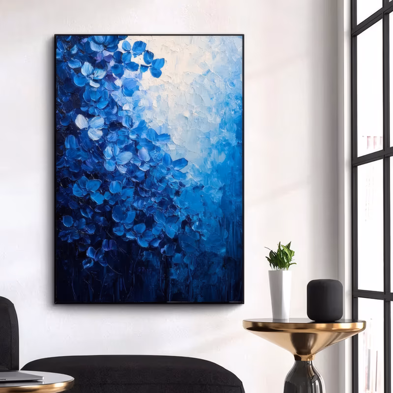 a large vertical textured floral canvas of dense cobalt and royal blue blossoms massed at the left and bottom, thinning toward a soft white glow at the upper right, with navy shadows below, in thick knife-applied paint