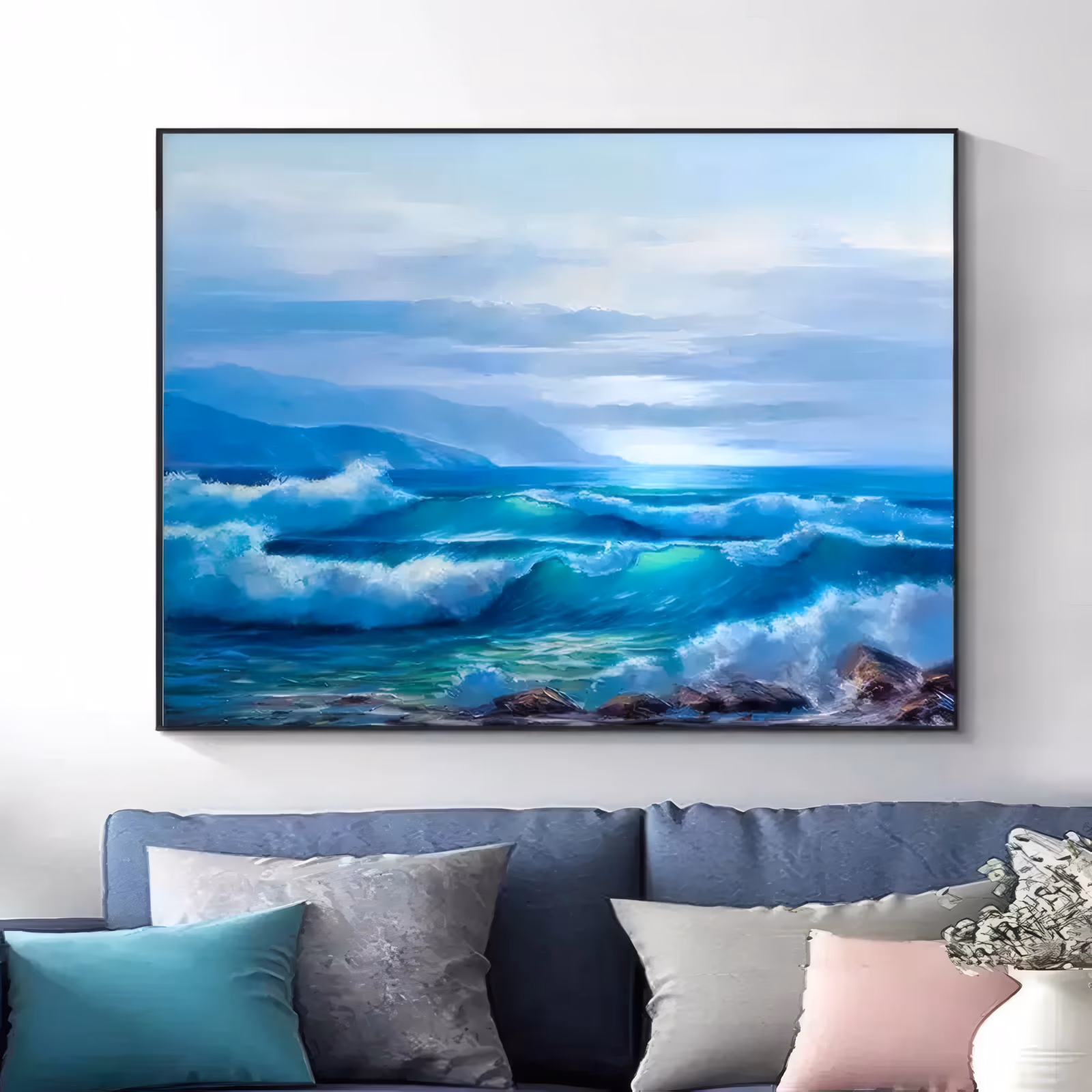 a wide horizontal realistic seascape painting of turquoise waves breaking into white foam over dark wet rocks at the lower right, with blue headlands and a pale cloudy sky behind, in soft oil