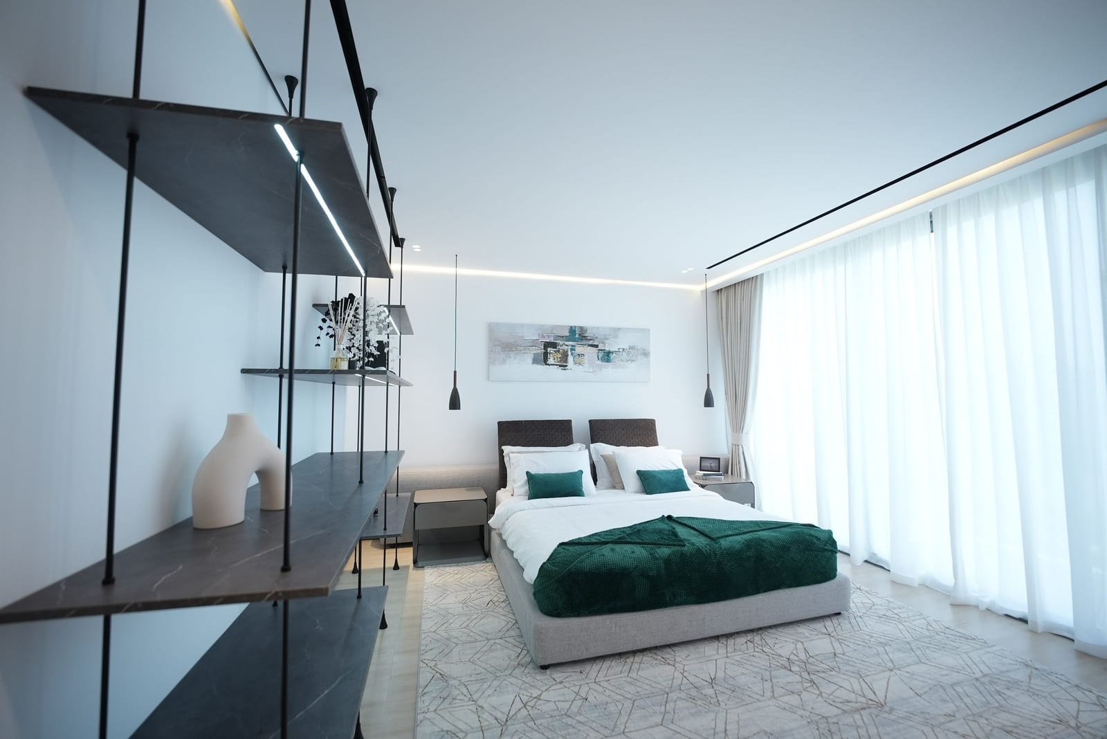 A white contemporary Gulf bedroom with a low grey bed, a single wide canvas above the headboard and floor-to-ceiling curtains, March 2024.