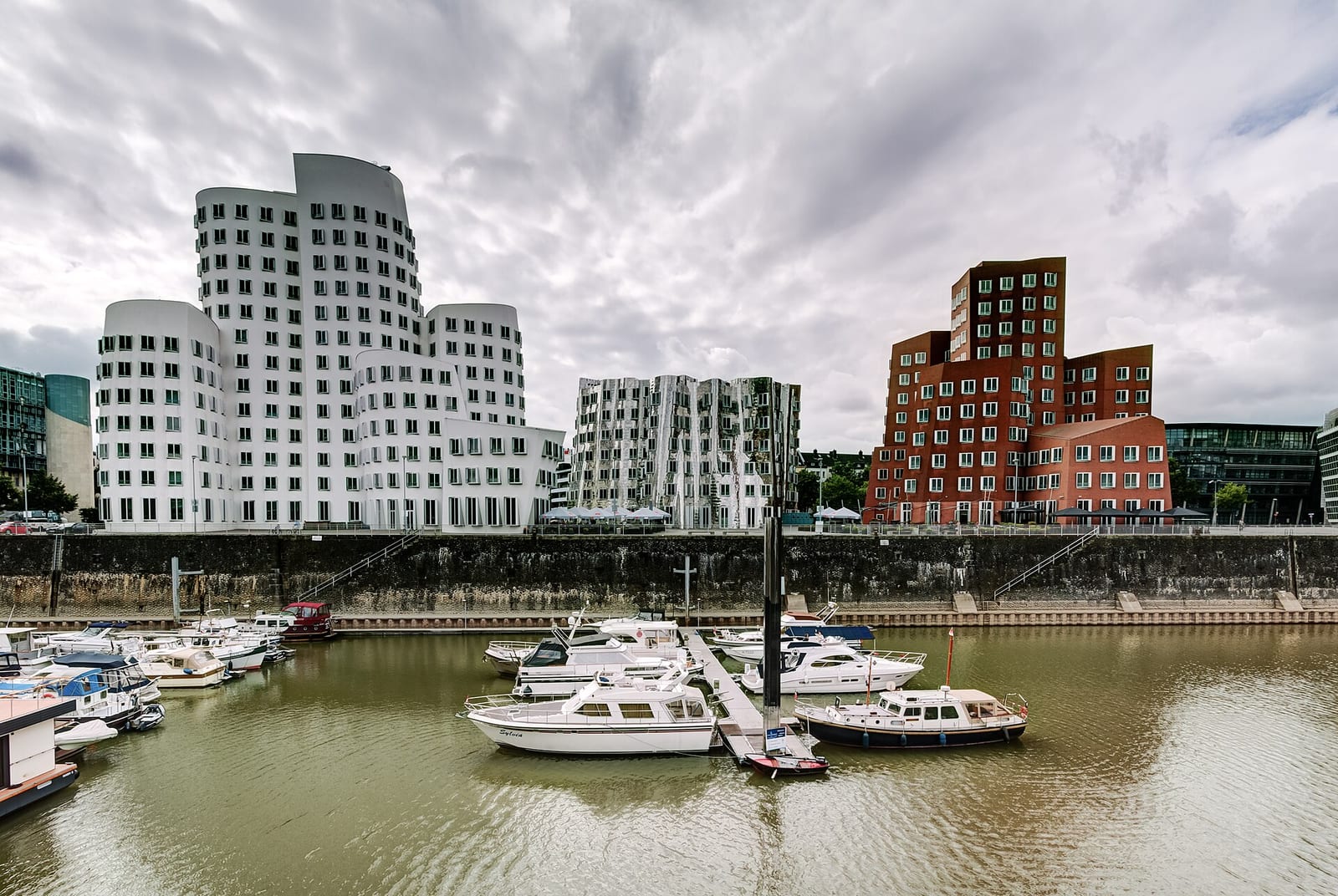 Frank Gehry's curved Neuer Zollhof buildings in Düsseldorf's Medienhafen at dusk