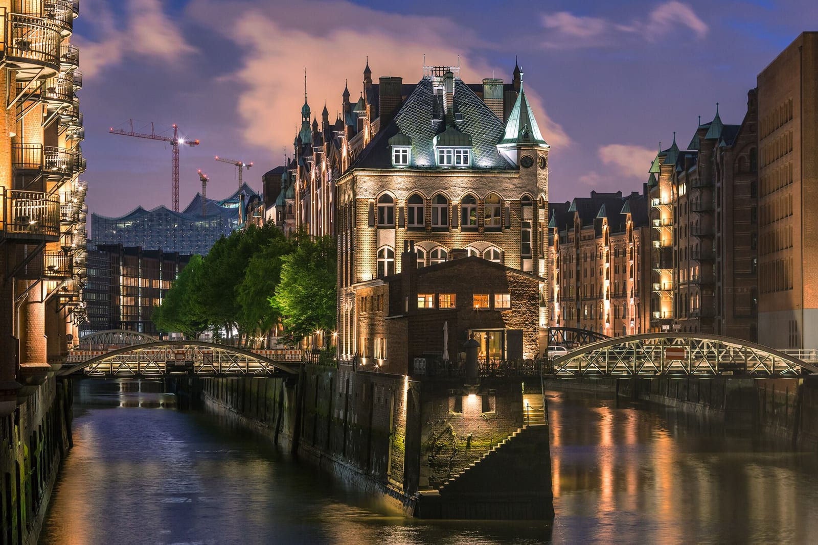 Hamburg Speicherstadt brick warehouses and canals lit at dusk