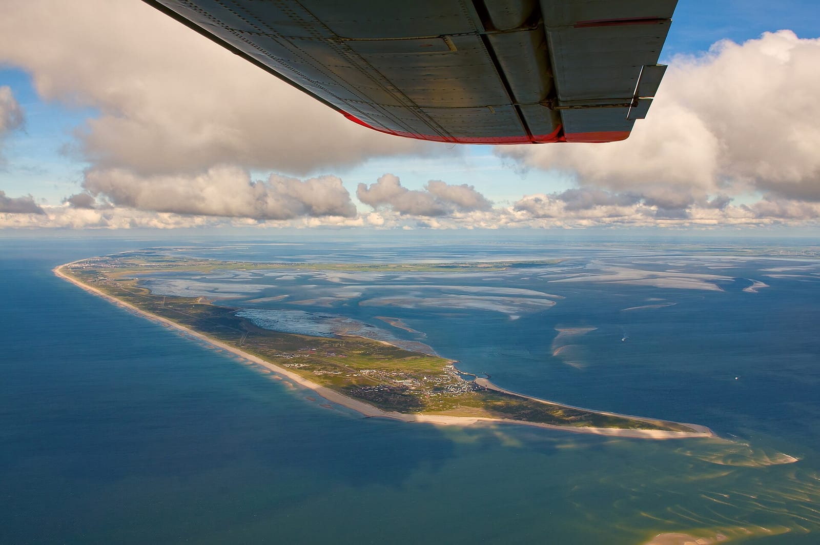 Aerial view of tidal channels in the North Frisian Wadden Sea with sand and grey water
