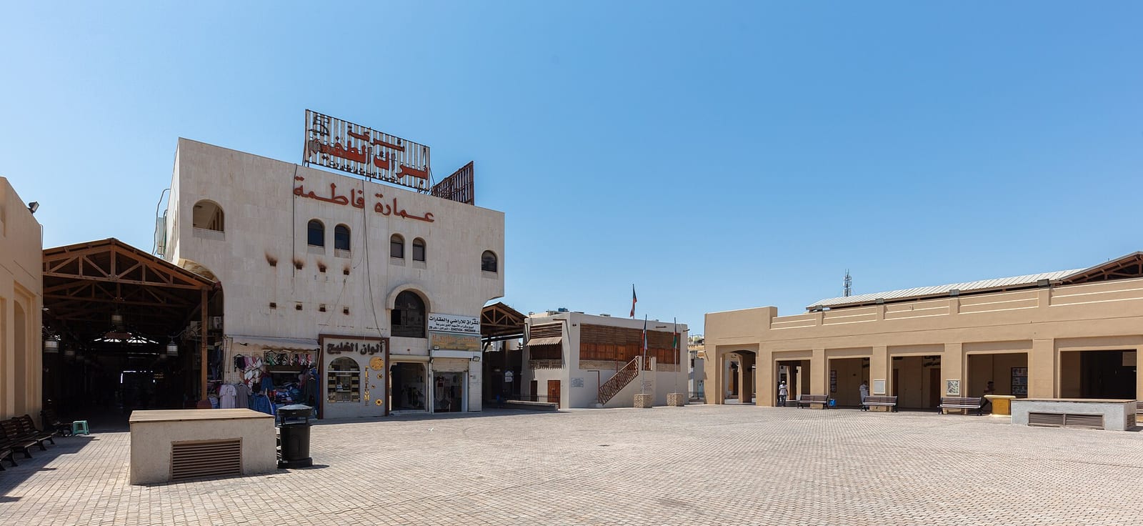 Wide panoramic view of Souq Al-Mubarakiya in Kuwait City with its covered walkways, shopfronts and outdoor seating, August 2024.
