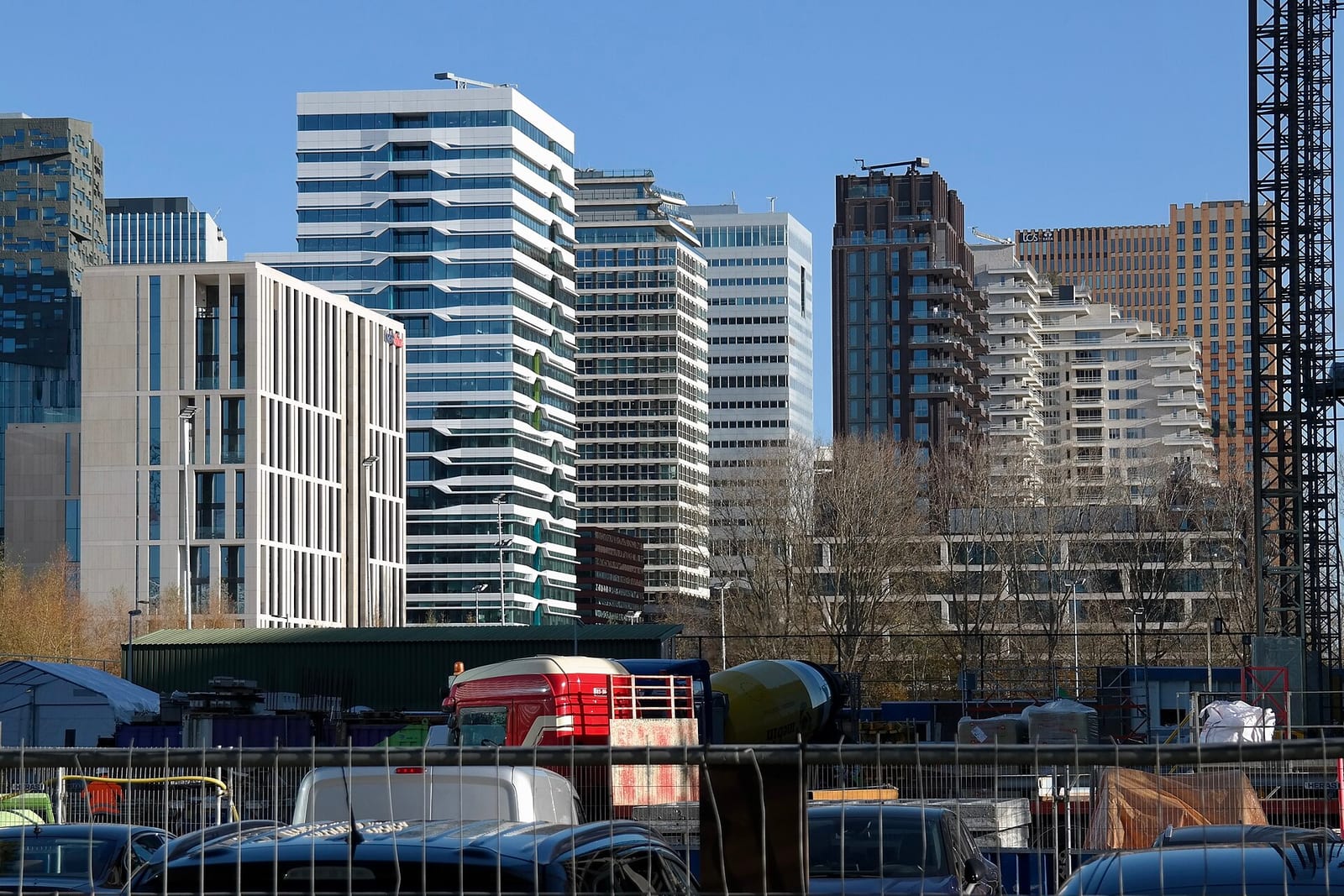 Office and residential towers of the Zuidas business district in Amsterdam seen across a construction site in 2021.