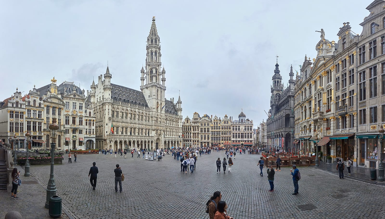 Panorama of the Grand-Place in Brussels with its gilded guild houses and Gothic town hall on a summer day.