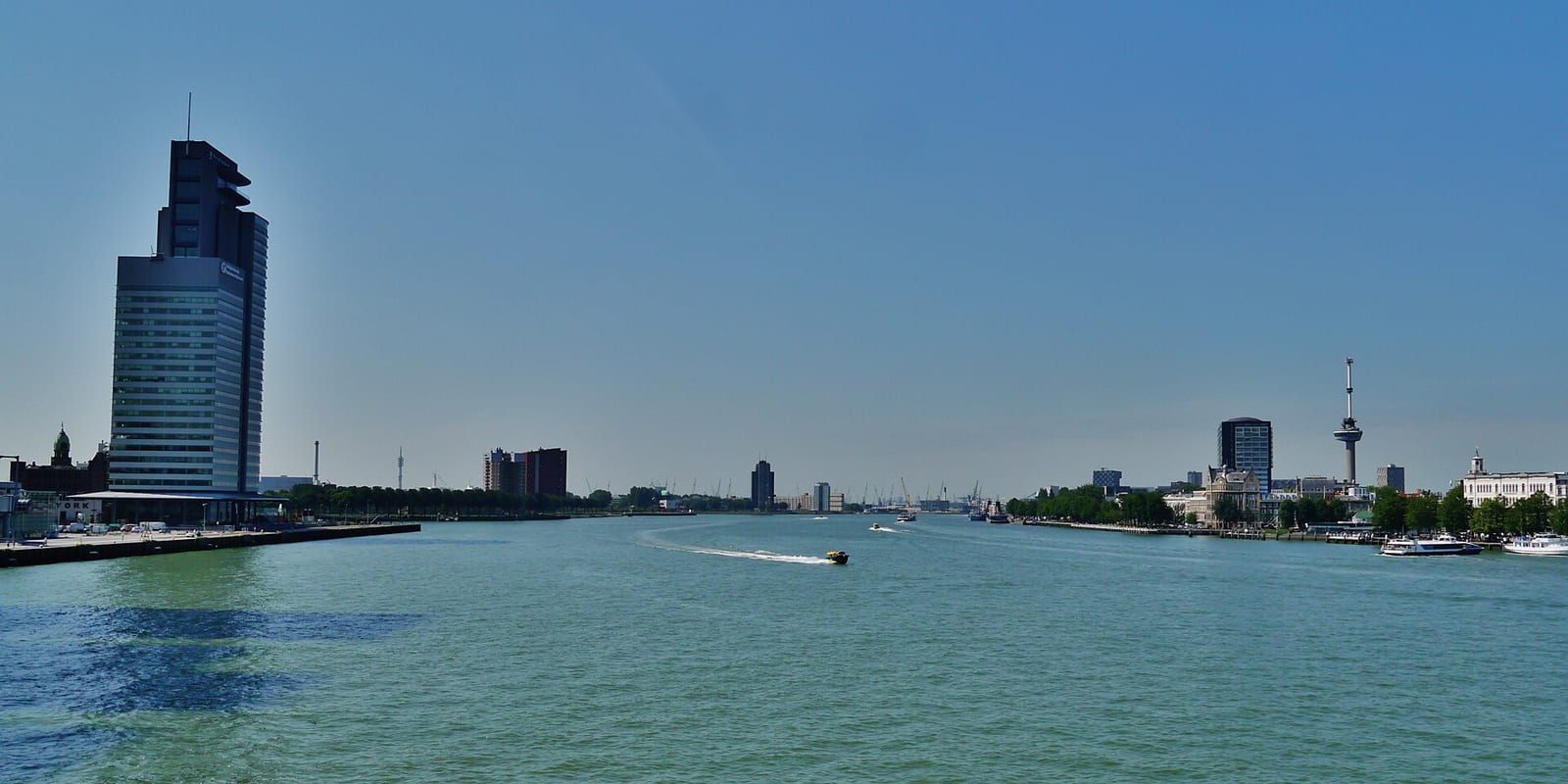 Panorama of the Kop van Zuid waterfront in Rotterdam from across the river, with the Montevideo and Maastoren towers.