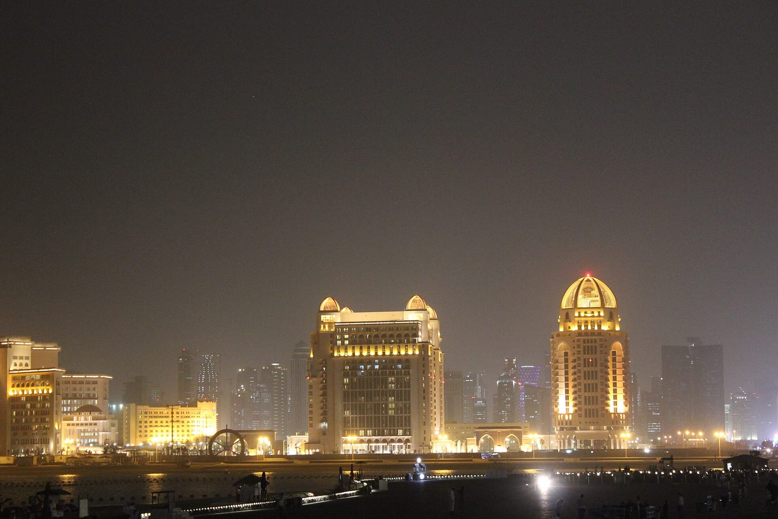 The residential towers of Porto Arabia on The Pearl-Qatar lit at night above the marina, February 2012.