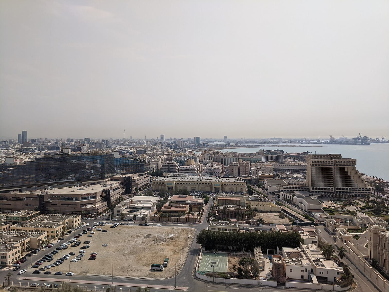 Daytime Jeddah skyline of mid-rise and high-rise towers under a hazy sky, February 2020.