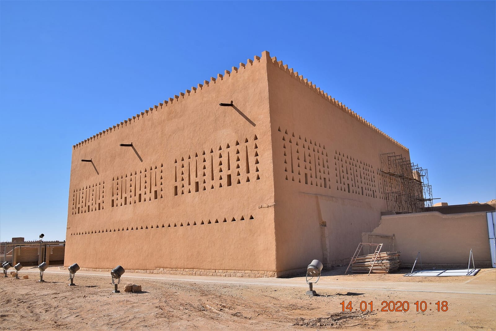 Restored mud-brick palace of Prince Saad in Diriyah with rows of triangular Najdi wall openings, 2020.
