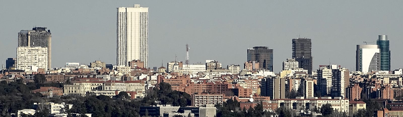 Wide view of the AZCA financial district skyscrapers along the Paseo de la Castellana in Madrid.