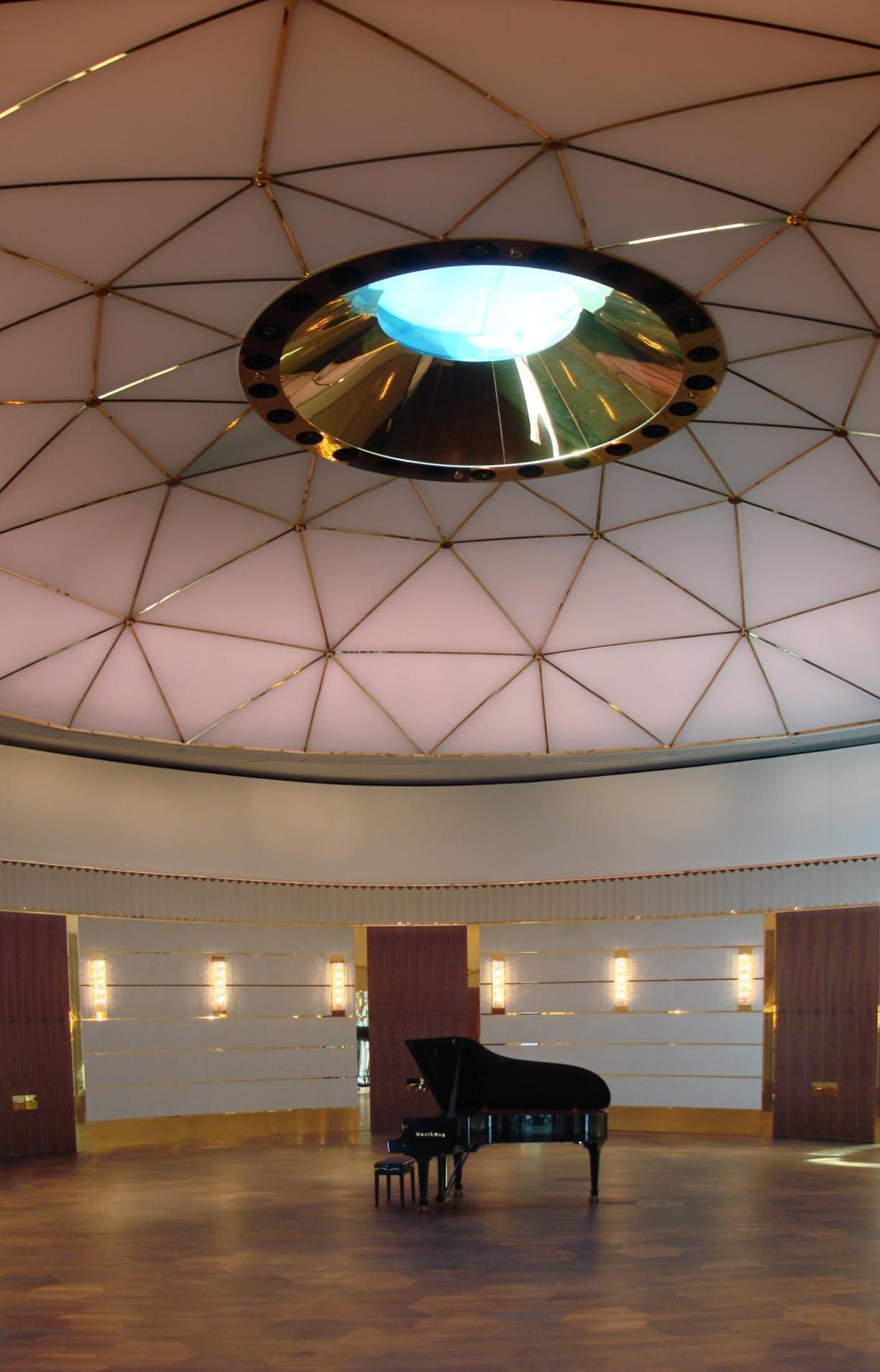 The domed ballroom of the Dolder Grand in Zürich, an empty round room with a grand piano under a circular skylight.