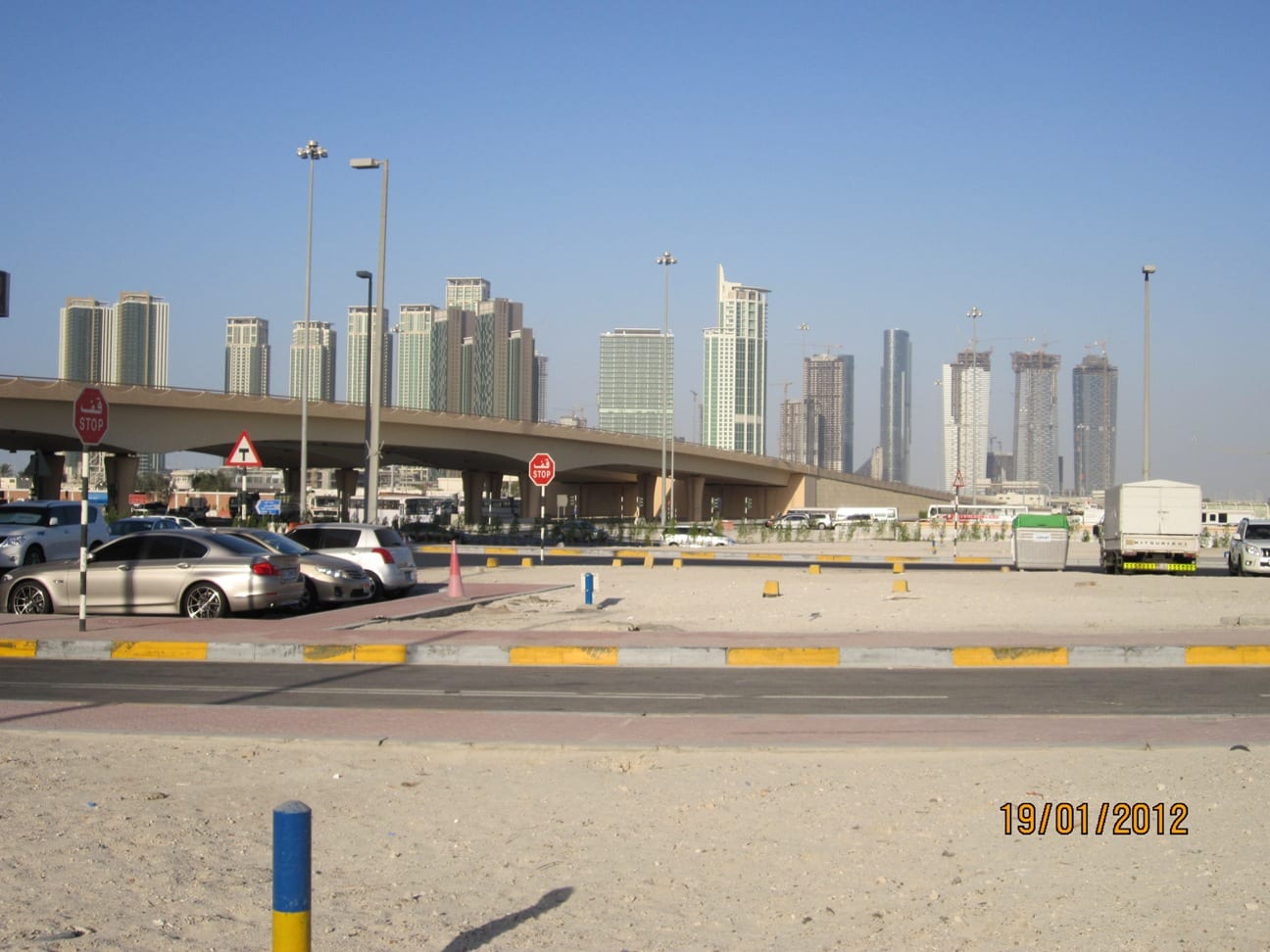 Residential towers of Al Reem Island, Abu Dhabi, seen across the water with construction cranes and new mid-rise blocks.
