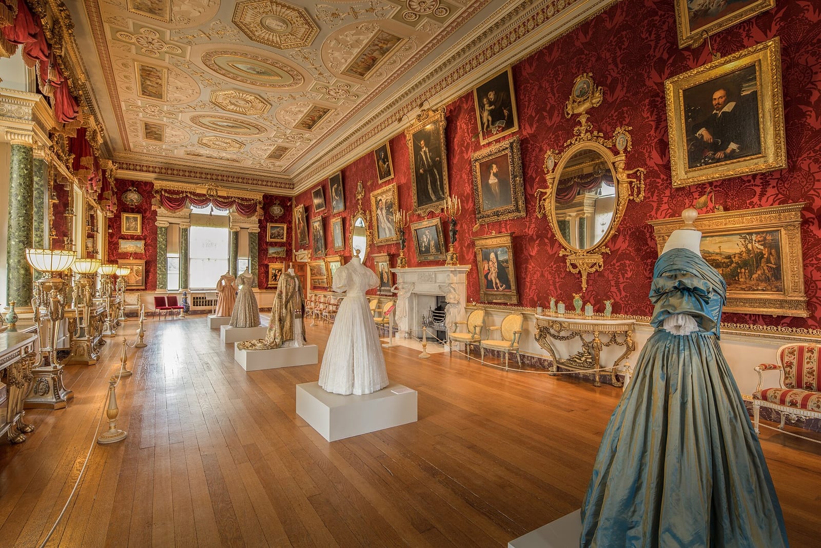 The long gallery at Harewood House, Yorkshire, with paintings hung in a row along a tall wall.
