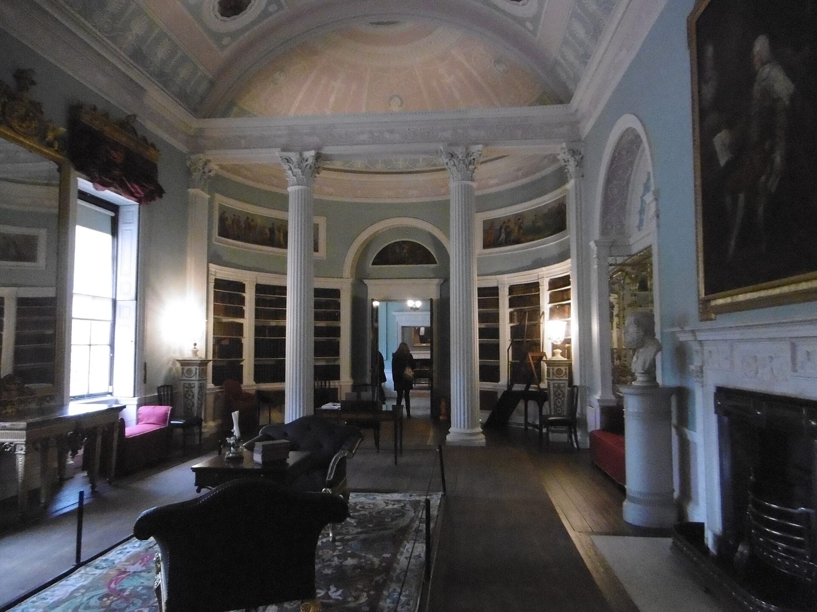 The neoclassical library at Kenwood House, Hampstead, with a coved painted ceiling and columns.