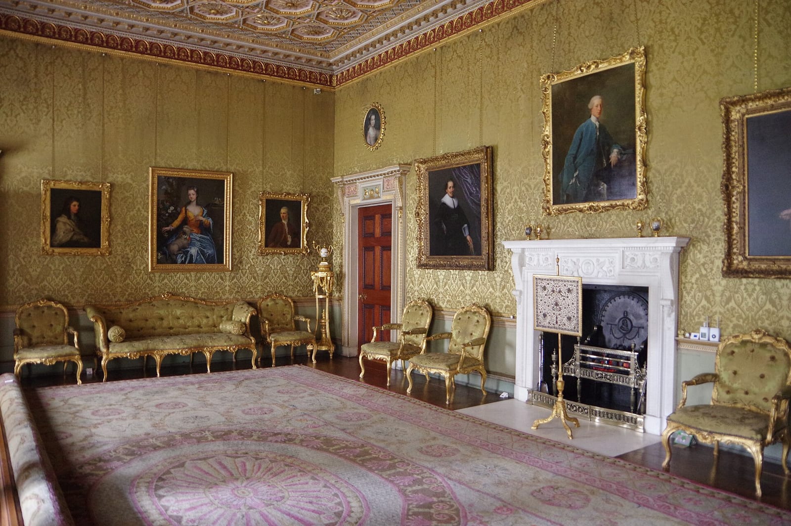 Formal drawing room at Osterley Park with tall walls, gilt furniture and large paintings above the dado.
