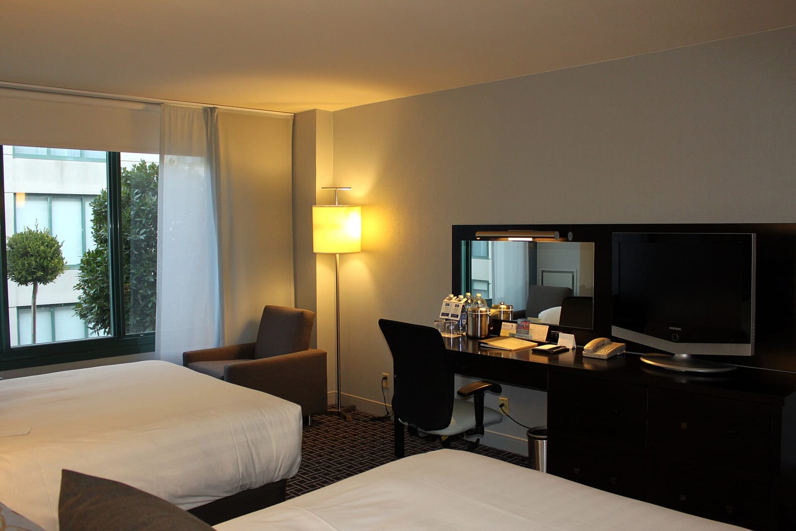 Standard hotel room with two double beds and framed art above the headboards, San Francisco, California.