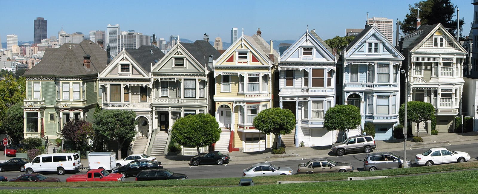 Row of Victorian Painted Ladies houses on Alamo Square with the San Francisco skyline behind, September 2008.