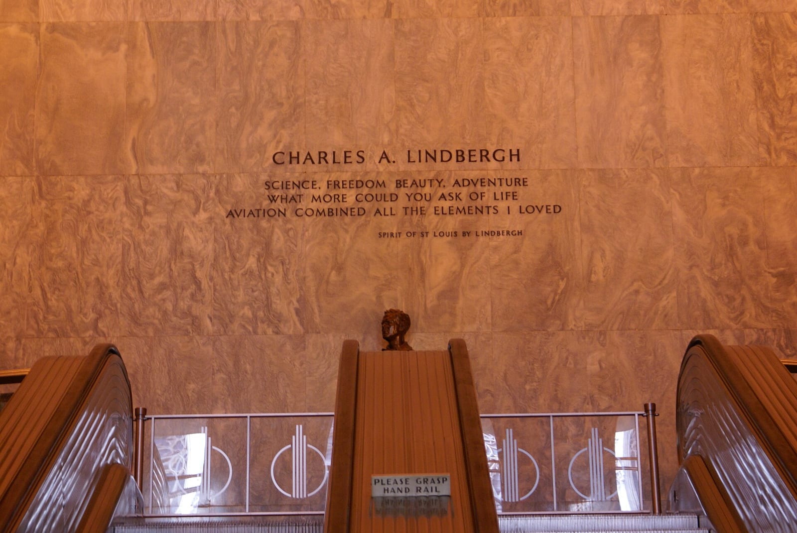 Art Deco lobby of Rockefeller Center, New York, with murals and polished stone walls, March 2010.