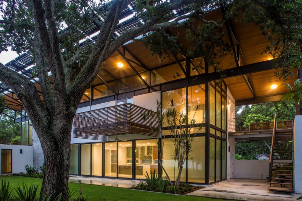 Modern Sarasota house with deep roof overhangs, glass walls and shaded outdoor living areas, 2010.