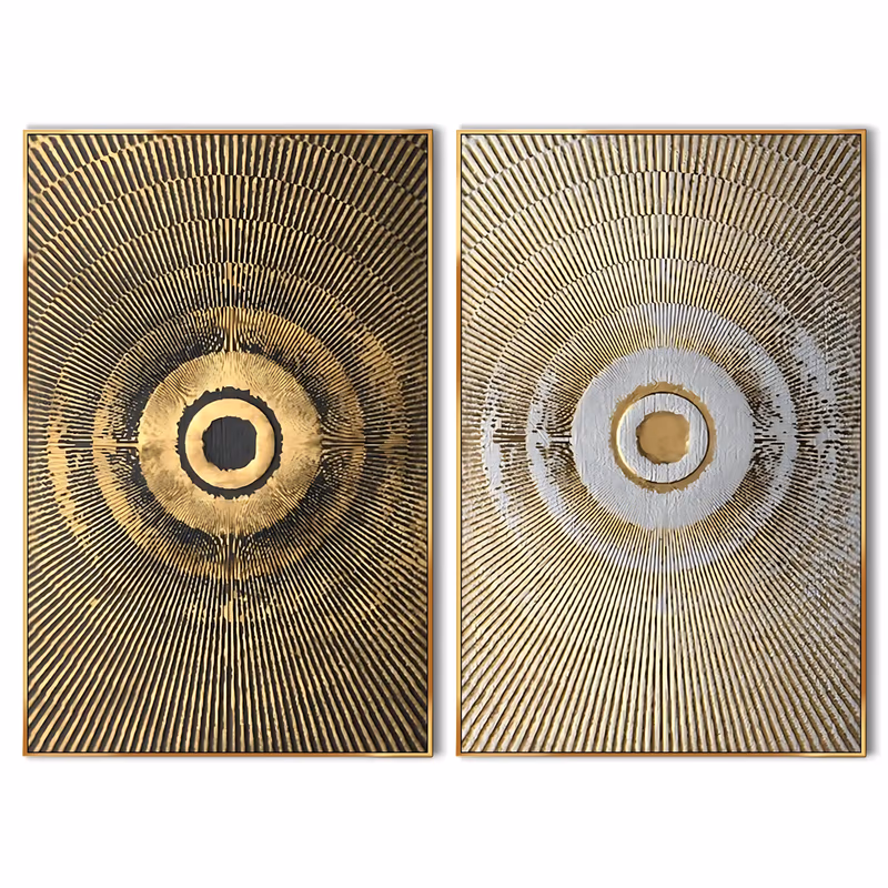 a set of two large vertical textured abstract paintings, each showing a radiating gold sunburst disc with a ringed center, one on a black ground and one on cream, carved in fine raised relief lines