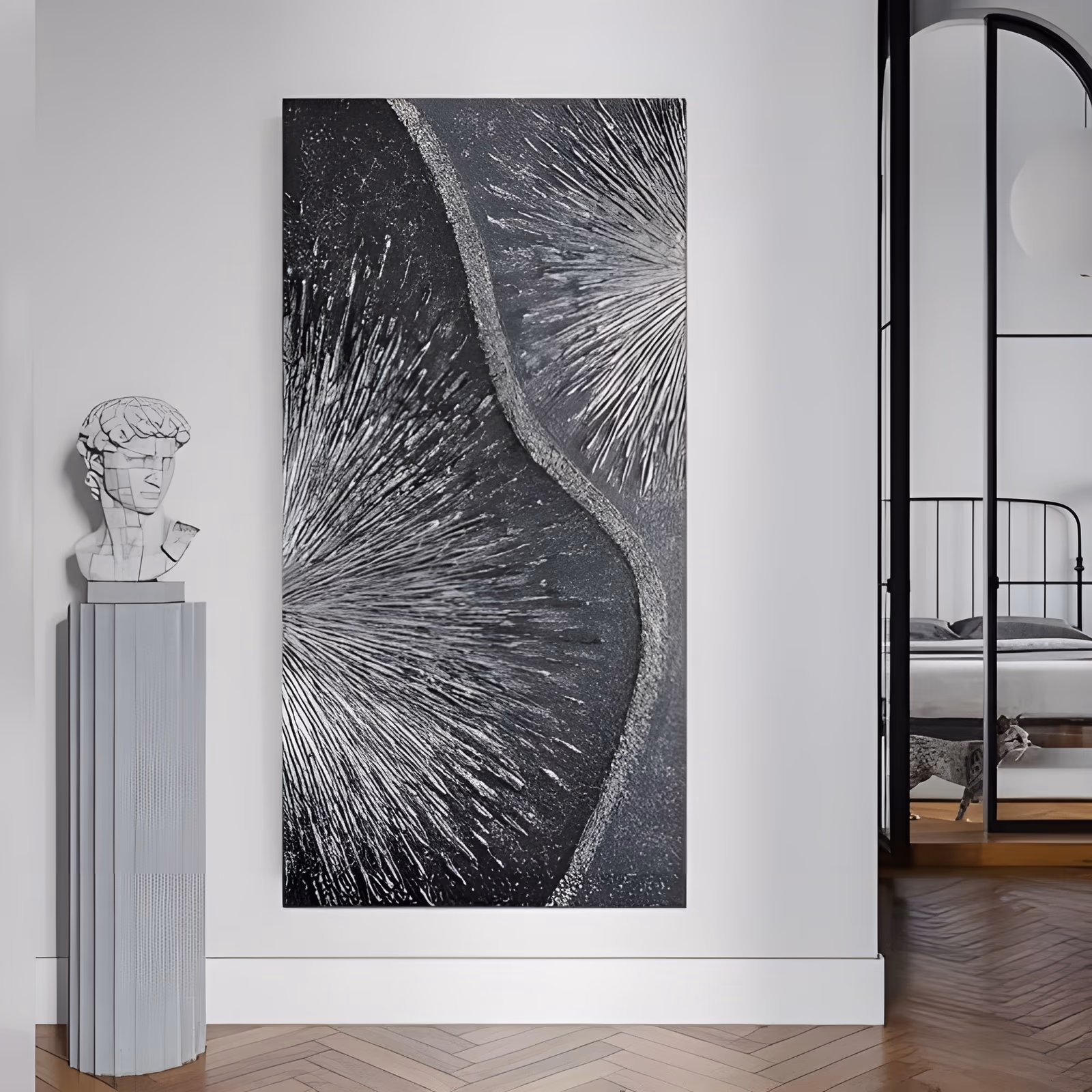 a tall narrow relief painting of two silver starbursts radiating from the left and right edges on a black grainy ground, divided by a curving raised silver band that runs from top to bottom